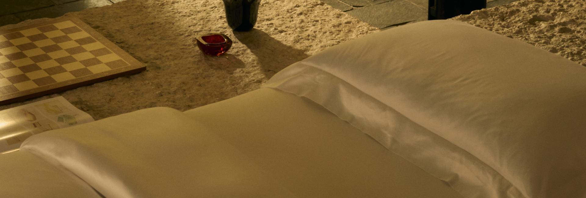 Close-up of a chessboard with a red piece on a stone surface